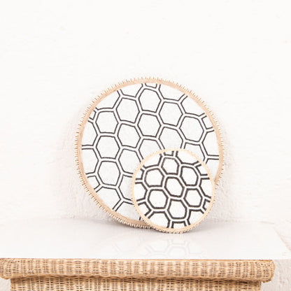 Beaded Cameroon shield in black and white on stand with hexagon light design, used as a stylish home decor piece.