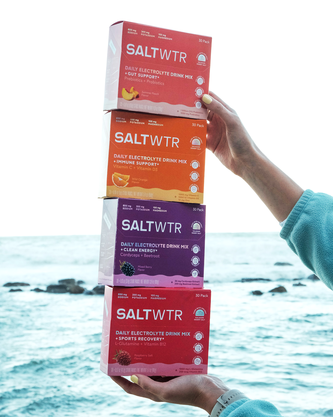 SaltWTR Variety Pack with multiple boxes of flavored saltwater products, displayed in a lifestyle setting.