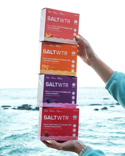 SaltWTR Variety Pack with multiple boxes of flavored saltwater products, displayed in a lifestyle setting.