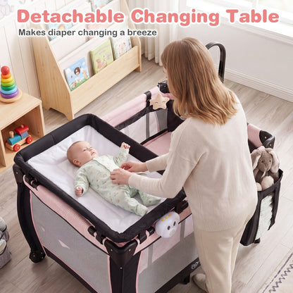 Pink baby playpen with changing table and bassinet, featuring soft mesh sides and sturdy frame for safe, versatile baby care.