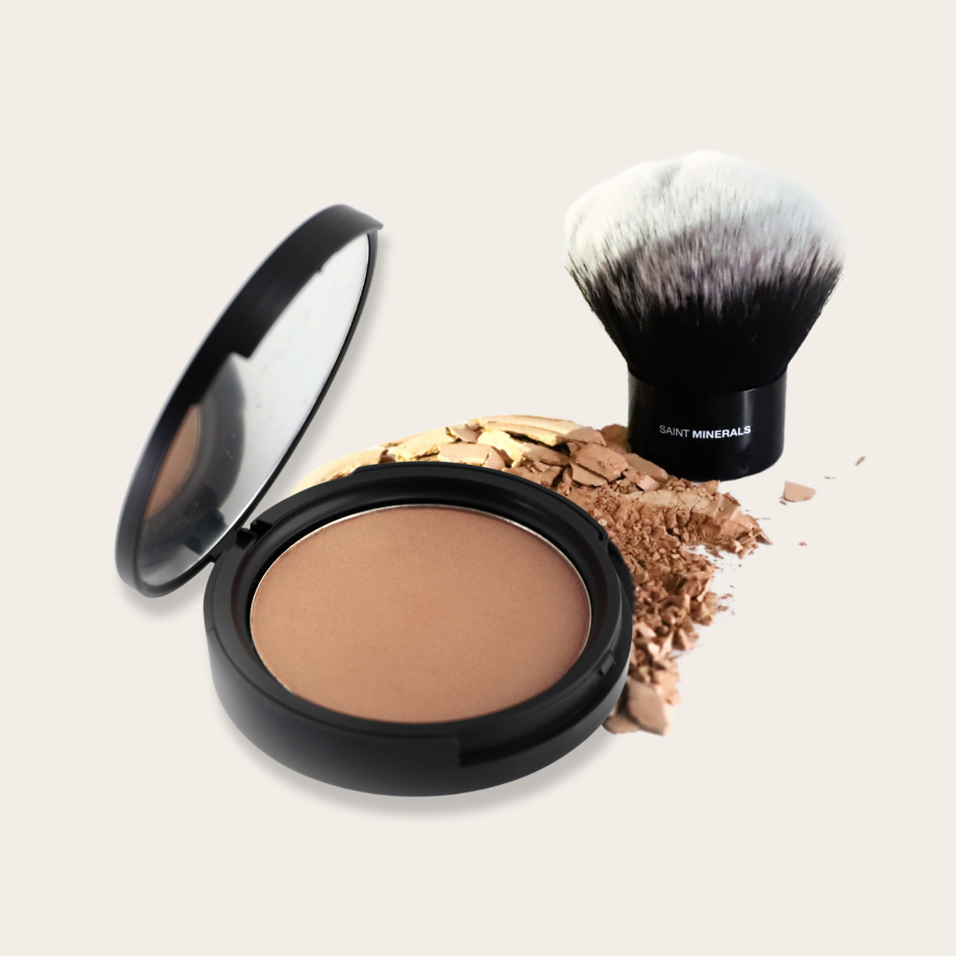 Pressed powder foundation by Saint Minerals in a compact case, showing a smooth, natural finish with a beige shade.