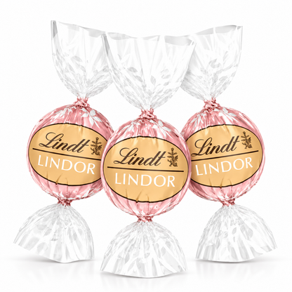 Lindt LINDOR Neapolitan white chocolate truffles in bulk, showcasing creamy white, pink, and brown layered chocolates in a clear bag.