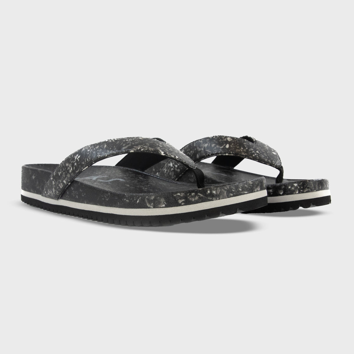 Fleks West Beach Flip Flops in Night color, showing a pair with black straps and textured soles from an angled view.