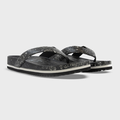 Fleks West Beach Flip Flops in Night color, showing a pair with black straps and textured soles from an angled view.