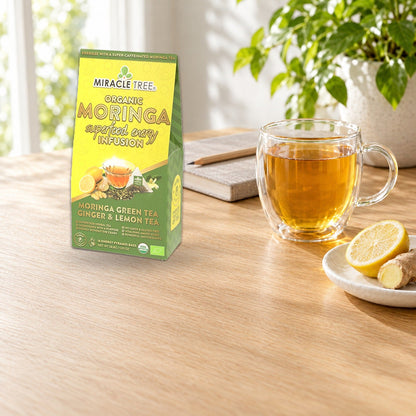 Organic Moringa Energy Tea by Miracle Tree with ginger and lemon, natural coffee alternative, served in a clear glass mug.