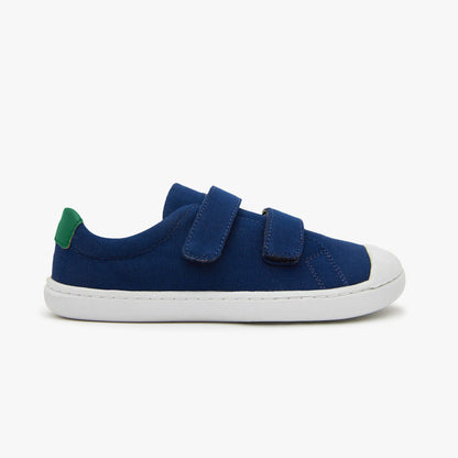 Blue cotton canvas barefoot shoes for kids with hook and loop fasteners, designed for comfort and flexibility by Origo Shoes.