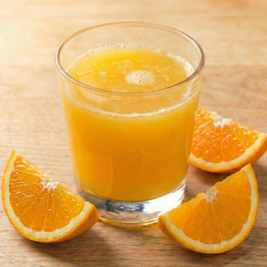 AmBari Nutrition orange fruit drink with vibrant orange color and fresh fruit slices, showcasing a refreshing beverage in a clear glass.