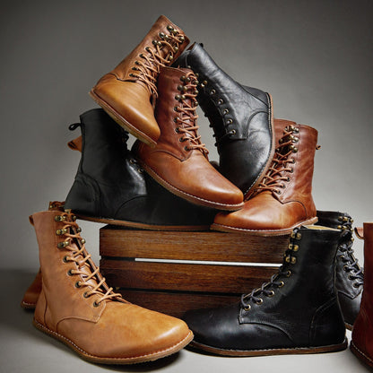 Black Origo Shoes women's adventure boots with a stylish, barefoot design, shown in a natural outdoor setting.