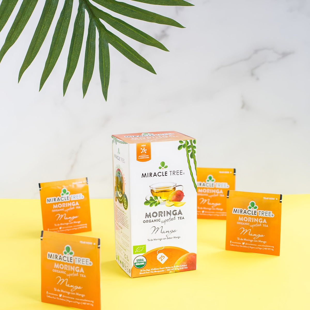 Organic Moringa Mango Herbal Tea by Miracle Tree in a tea bag, showcasing fresh ingredients and vibrant mango flavor.