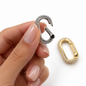 Oval CZ jewelry clasp by MIA J, showcasing a polished silver-toned clasp with sparkling cubic zirconia accents.