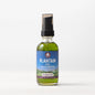Bottle of WishGarden Herbs Plantain Oil for body care, with plantain leaves and natural ingredients visible in the background.