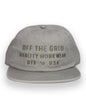 Off The Grid Surplus plated hat in eucalyptus color, featuring a stylish and durable hat design with a metal plated finish.