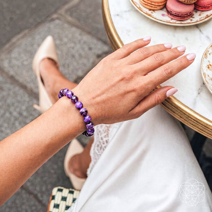 Close-up of the Unshakeable Intuition Siberian Charoite bracelet by Conscious Items, showcasing smooth purple gemstone beads on a stretch cord.