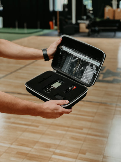 iReliev SPORT TENS + EMS Muscle Stimulator in case, compact TENS unit for pain relief and muscle therapy.