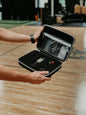 iReliev SPORT TENS + EMS Muscle Stimulator in case, compact TENS unit for pain relief and muscle therapy.