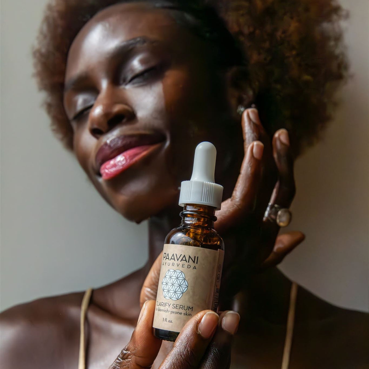 Paavani Ayurveda Clarify Serum in a glass bottle with dropper, Ayurvedic face oil for blemish-prone skin on a neutral background