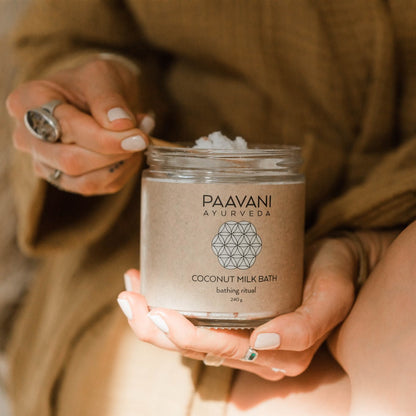 A simple image of a coconut milk bath product by Paavani Ayurveda Skincare, featuring a soothing herbal soaking ritual for skin and spirit.