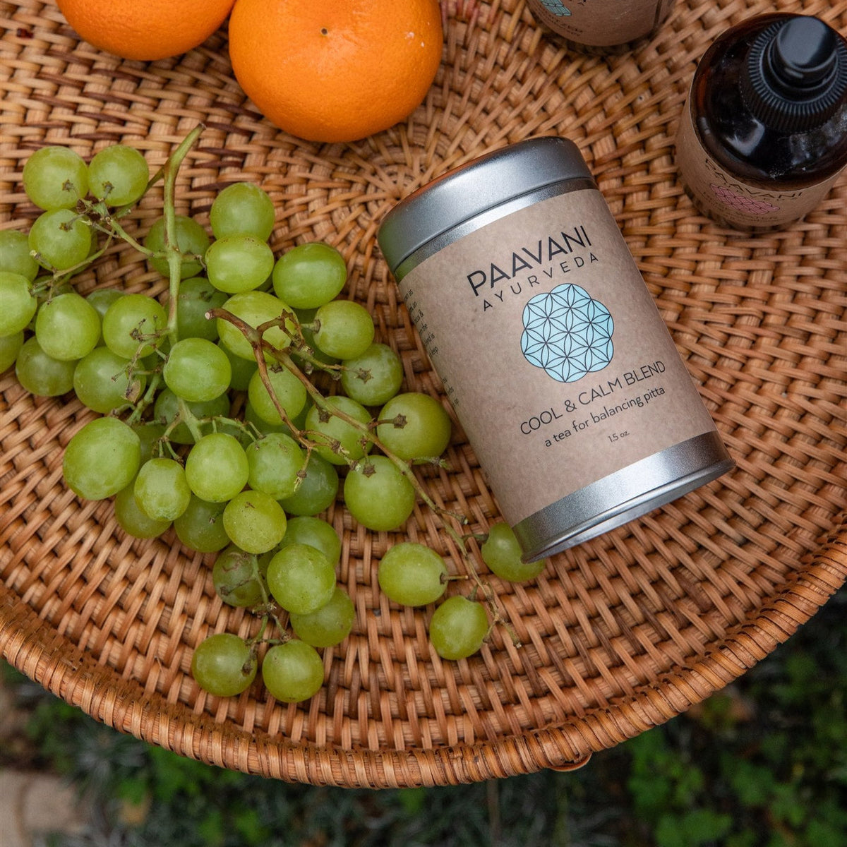Paavani Ayurveda Cool & Calm Blend Ayurvedic tea for Pitta balance in a clear glass cup with herbs and tea leaves.