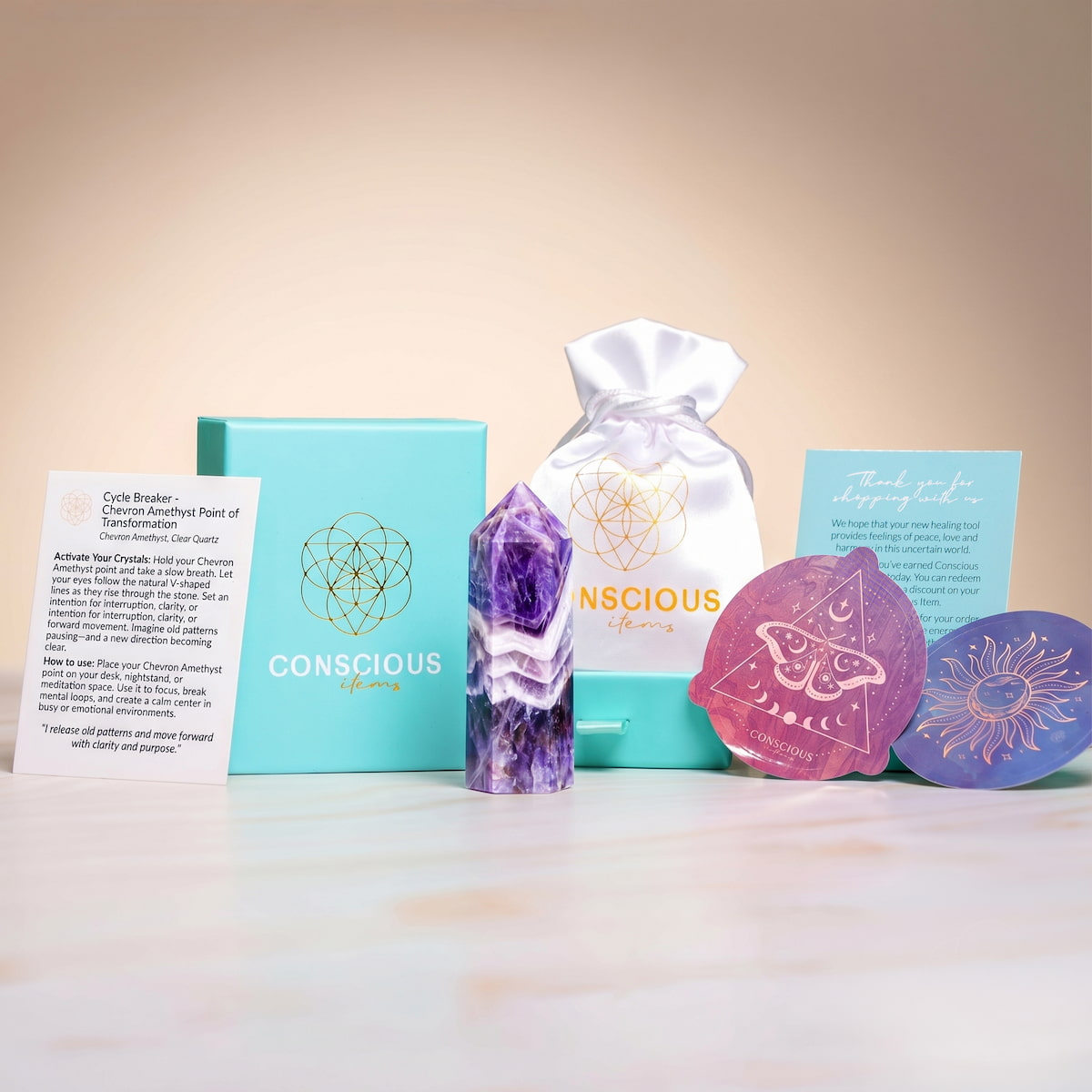 Chevron Amethyst Point of Transformation in packaging, a home decoration by Conscious Items featuring a vibrant purple and white crystal.
