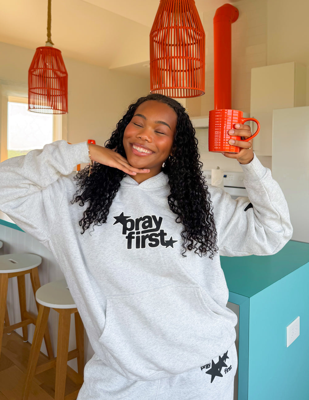 Unisex Pray First Hoodie by Elevated Faith featuring prayer-themed graphics and comfortable fabric for casual wear.