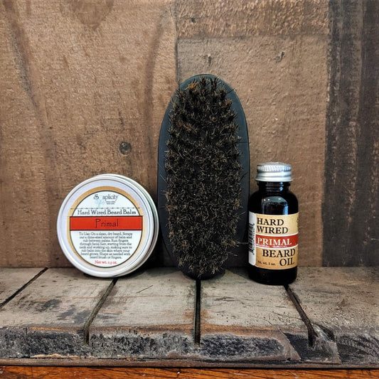 Primal Trio beard gift set by Soaplicity featuring wired beard oil, balm, and brush for grooming and styling.