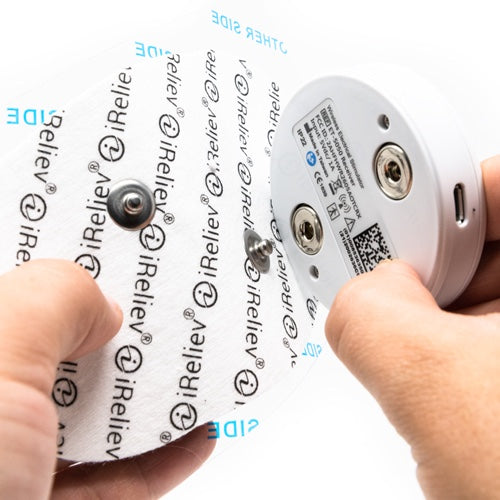 iReliev TENS Unit, a therapeutic wearable TENS+EMS system designed for pain relief and muscle stimulation.