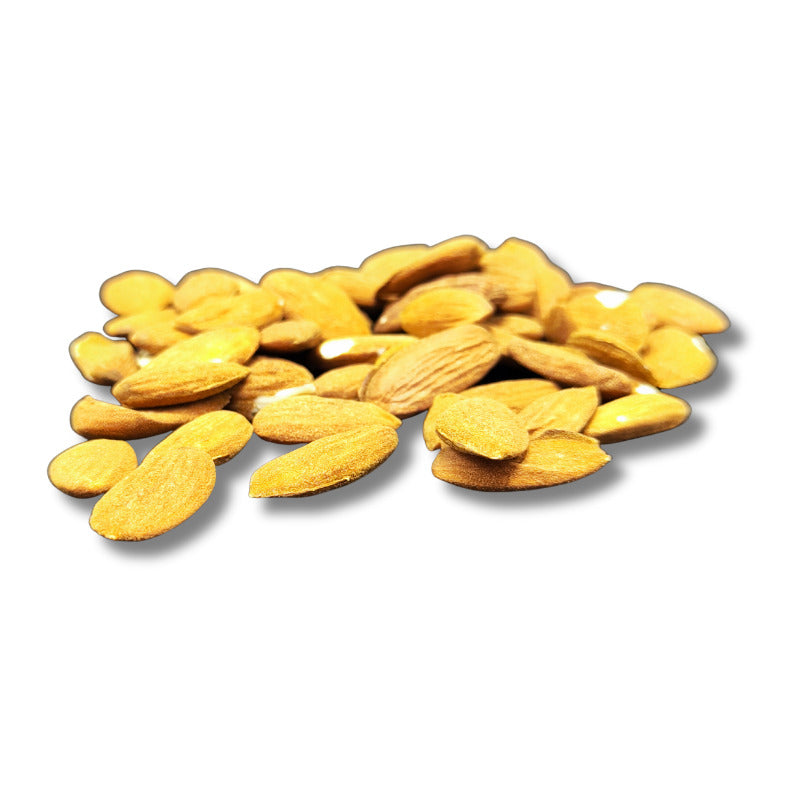 Dried Avola almonds from Nutty, shelled and aromatic, displayed in a bowl on a rustic wooden surface.