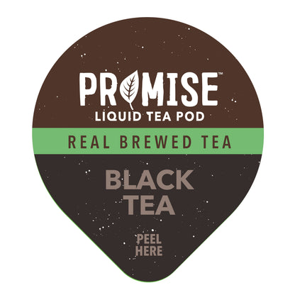 Glass of Promise Real Brewed Black Tea by Java House with a tea bag and fresh black tea leaves on a wooden table.