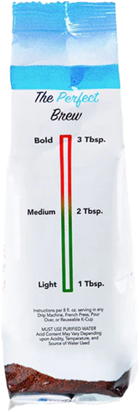 Regular acid-free ground coffee by Tylers Coffees in a bag with a coffee scoop and beans on a wooden surface.