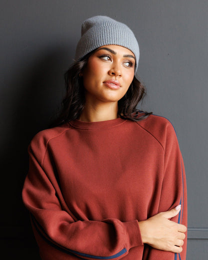 Downeast Alpine Beanie with retro stripe pattern, knit hat featuring colorful horizontal stripes and a snug fit for warmth.