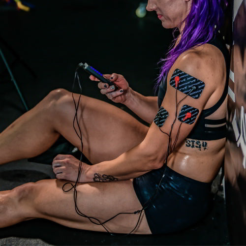 iReliev SPORT TENS + EMS muscle stimulator device with control buttons and display screen for pain relief and muscle therapy