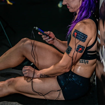 iReliev SPORT TENS + EMS muscle stimulator device with control buttons and display screen for pain relief and muscle therapy