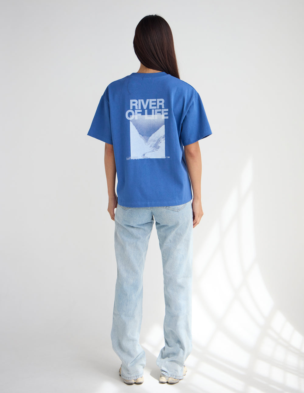 Black heavyweight T-shirt with River of Life graphic design from Elevated Faith, featuring vibrant river and spiritual imagery.
