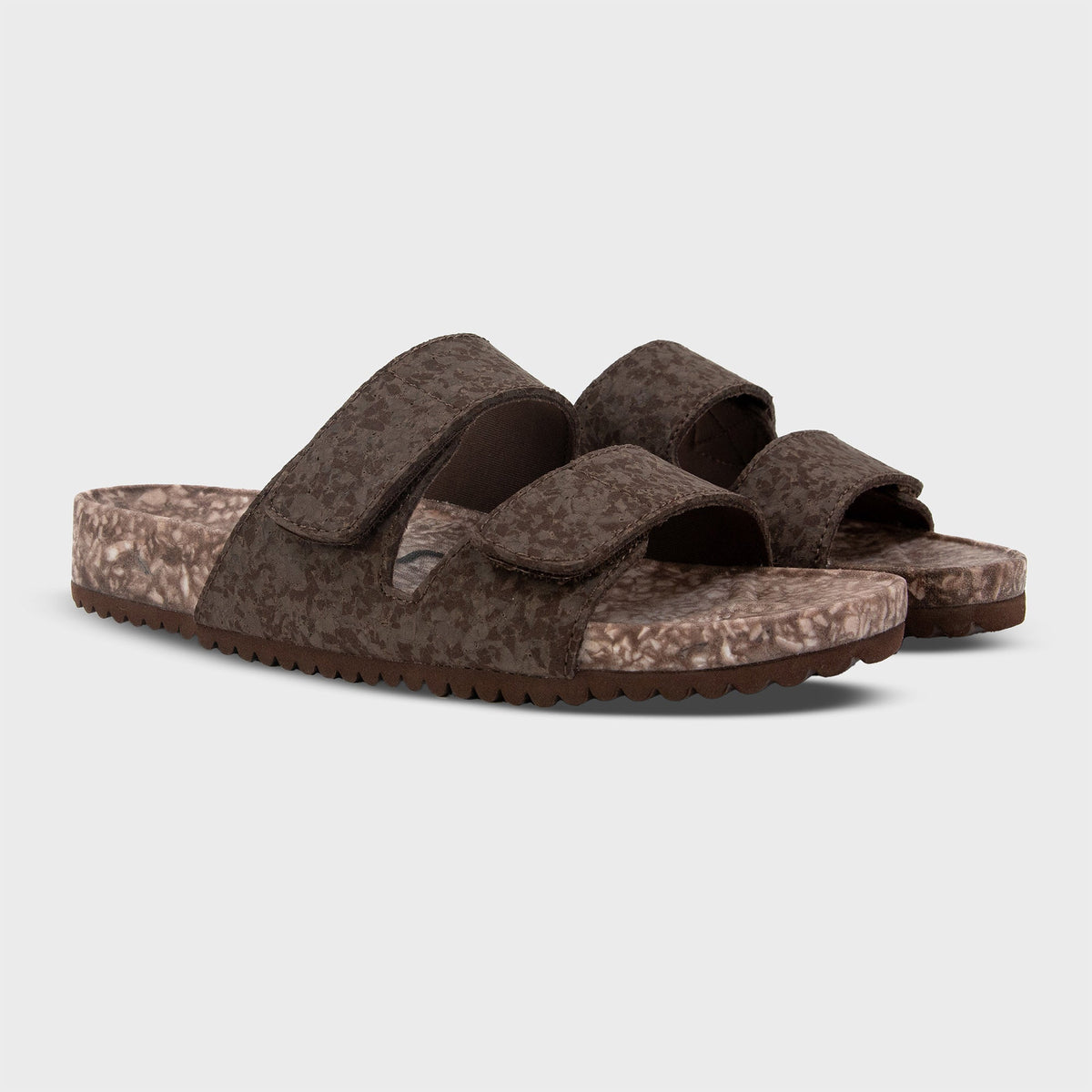 Pair of Fleks Riviera Sandals in coconut shell color shown from a side angle, featuring a sleek sandal design with thong straps.