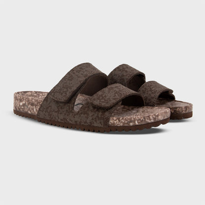 Pair of Fleks Riviera Sandals in coconut shell color shown from a side angle, featuring a sleek sandal design with thong straps.