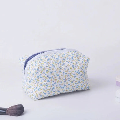 Blushimmer floral quilted makeup bag with large floral print, puffy design, and multiple compartments for travel cosmetics and accessories.