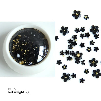 White acrylic flower nail art decorations with mixed size rhinestones and colorful gems for DIY manicure designs.