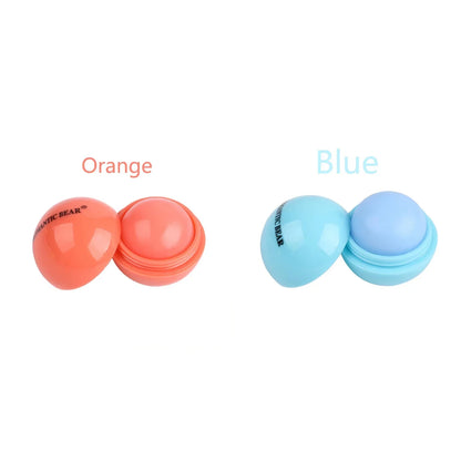 Blushimmer cute ball-shaped lip balm in pastel pink with a non-stick cup, showing its hydrating and soothing lip plumper design.