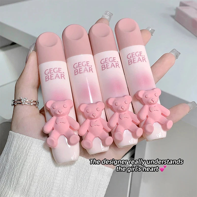 Blushimmer cute bear-shaped lip glaze and matte lipstick in a soft pink shade, held in hand showcasing creamy lip color.