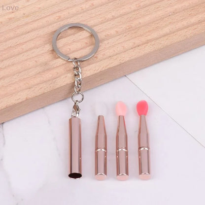 Blushimmer multifunctional silicone lip and eyeshadow brush with cover and keychain, portable and dustproof for easy makeup application.