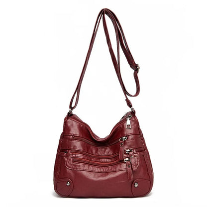 OBA women's multi-layer red leather shoulder crossbody bag with multiple compartments and adjustable strap.