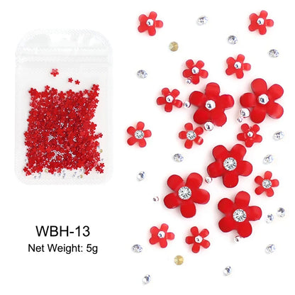 White acrylic flower nail art decorations with mixed size rhinestones and colorful gems, for DIY manicure accessories.