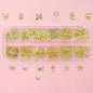 Set of 120 gold bow and butterfly nail charms with shiny star accents, perfect for luxurious nail art decorations.