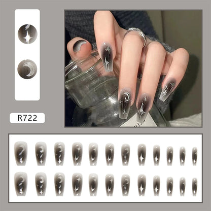 Set of 24 Y2K star-themed press-on nails by Blushimmer featuring gradient black, mid-length coffin shape with moon designs.