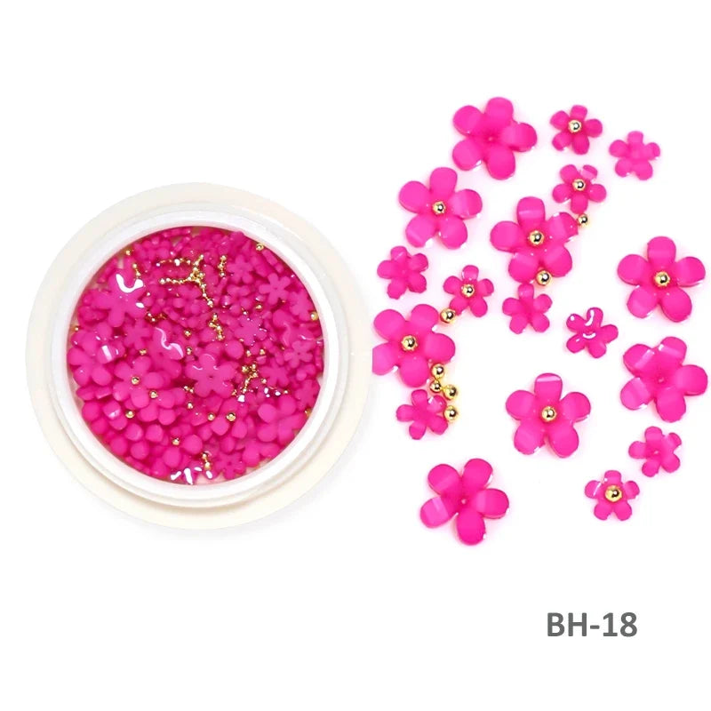 White acrylic flower nail art decorations with mixed size rhinestones and colorful gems for DIY manicure designs.