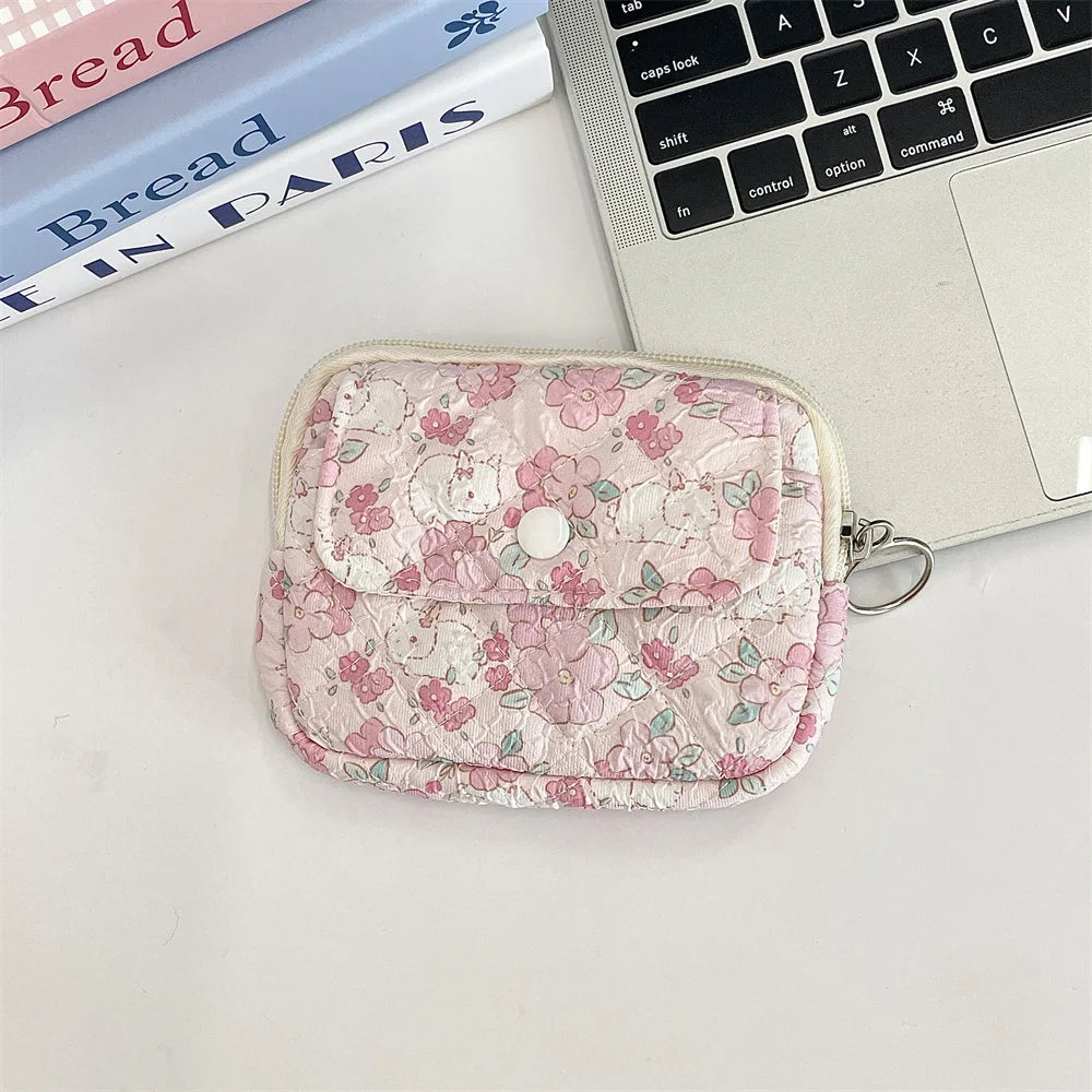 Cute cartoon travel cosmetic pouch by Blushimmer with lipstick, earphone, and card compartments for women’s makeup and accessories.