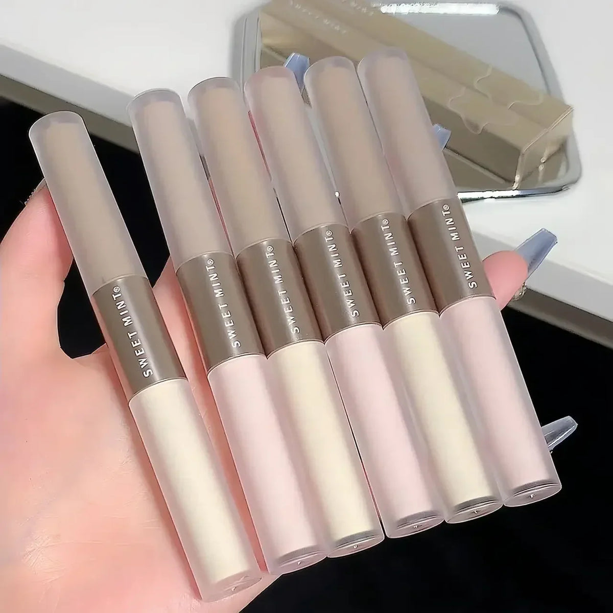 Blushimmer double-ended highlighting and contouring stick with concealer pencil in cement grey for nose shaping and makeup enhancement.
