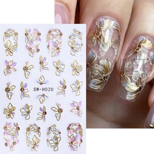 Metallic gold line flower nail stickers with 3D bronzing borders, sakura petals, and leaves for elegant manicure decor by Blushimmer.