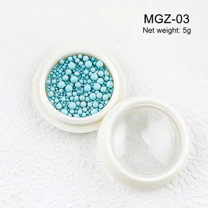 White acrylic flower nail art decorations with mixed size rhinestones and red and blue gems for DIY manicure design from Blushimmer.