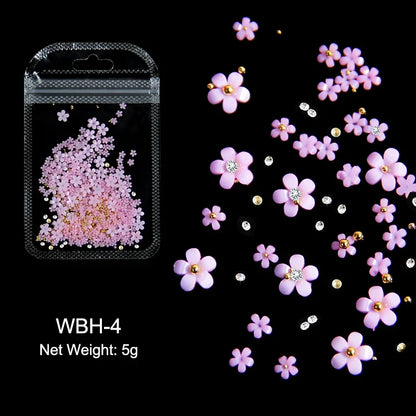 White acrylic flower nail art decorations with mixed size rhinestones and colorful gems for DIY manicure designs.